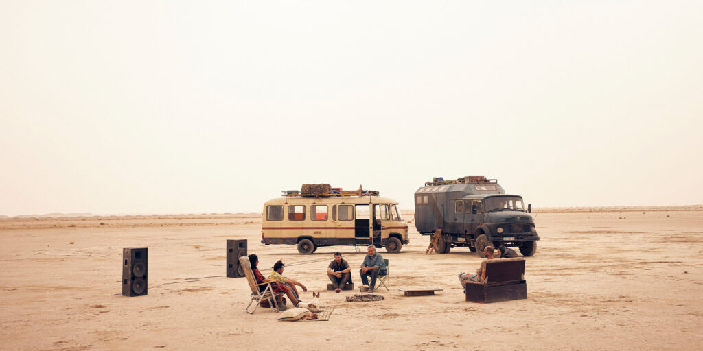 People sat in front of lorries in the desert