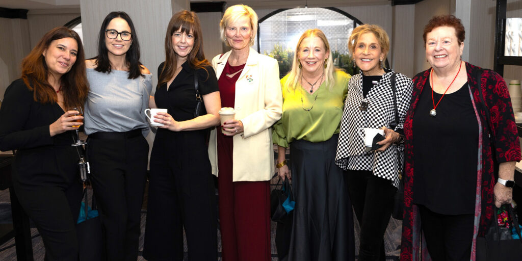 A group of women stood together smiling