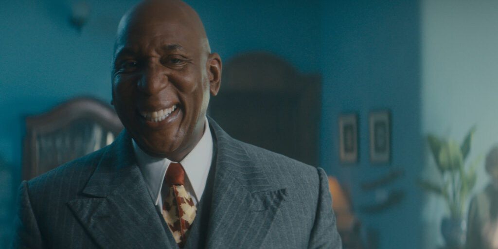 A man in a suit smiling