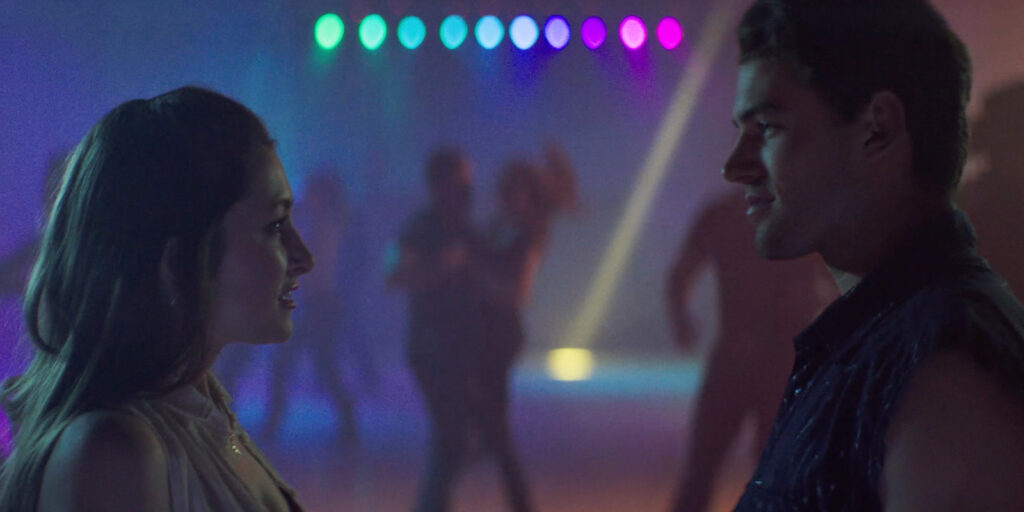 Two people dancing under neon lighting