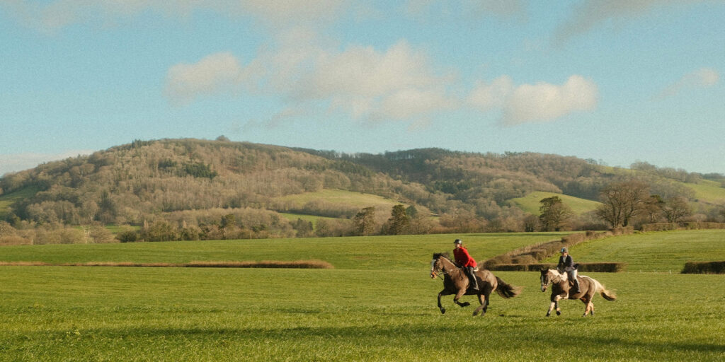 Two people riding horses