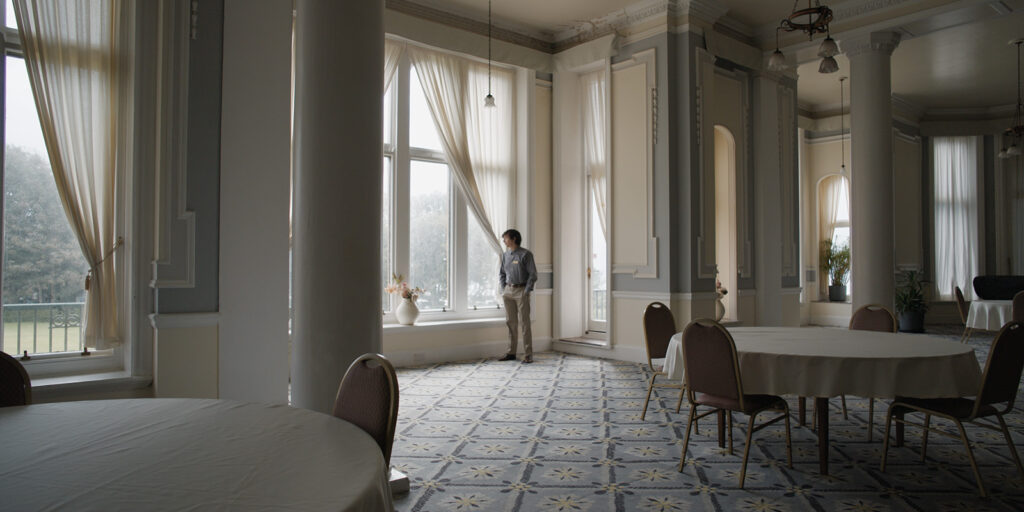 A man standing in a hotel dining room