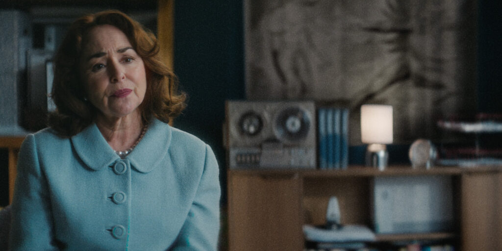 A woman sat in a blue suit