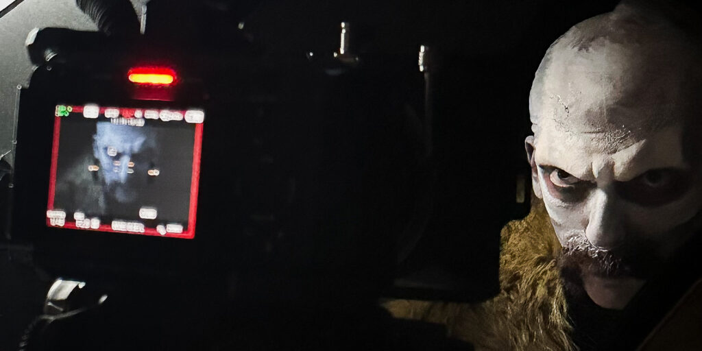 A man dressed as Count Orlok in front of a camera