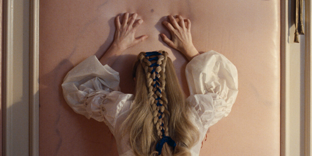 A woman leaning on a wall