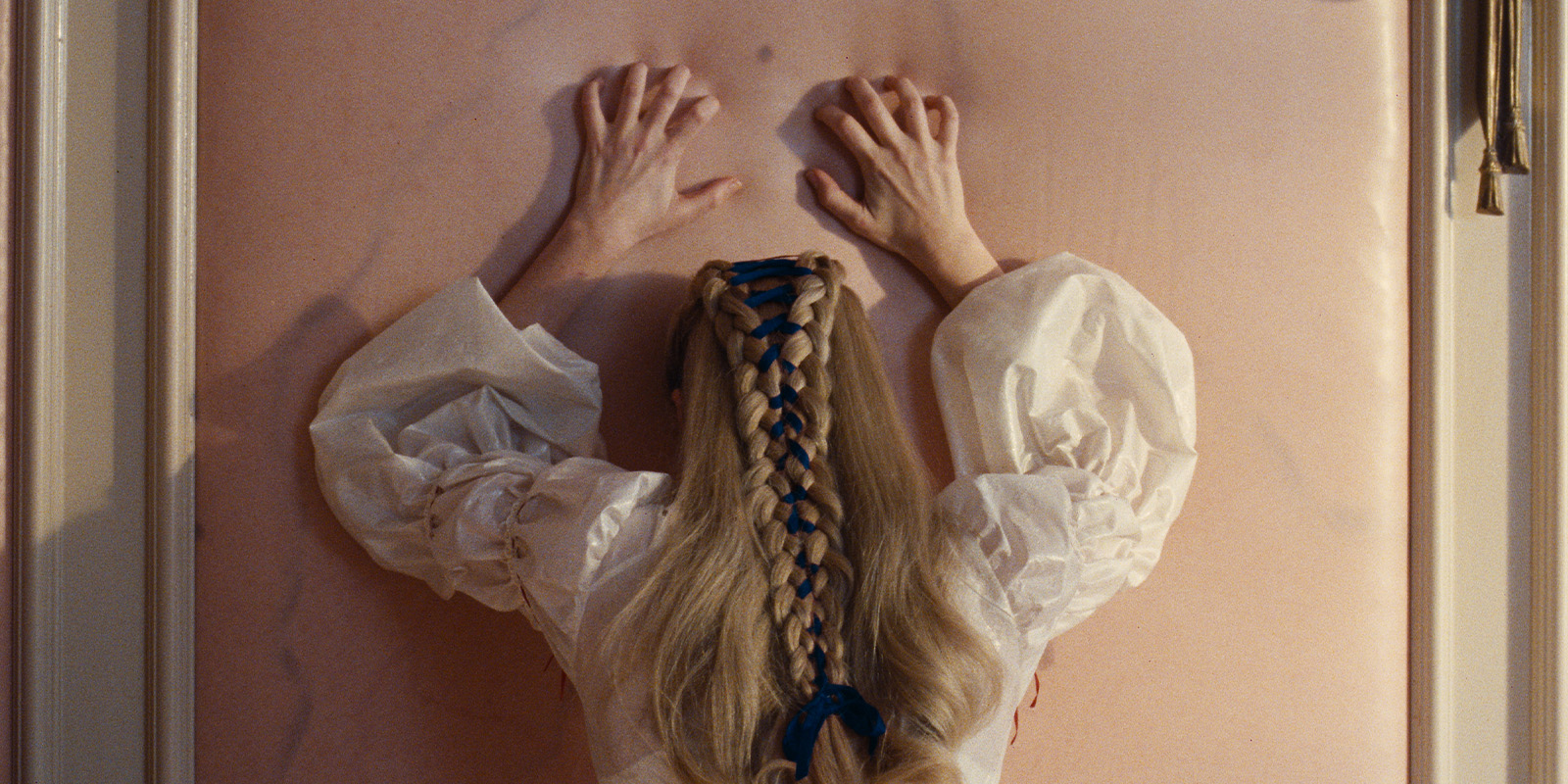 A woman leaning on a wall