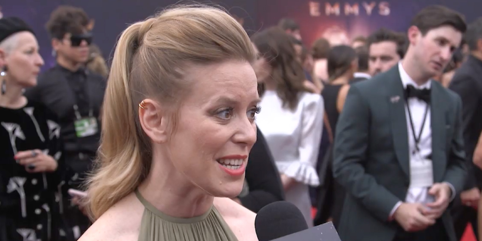 Zoë White speaking into a microphone