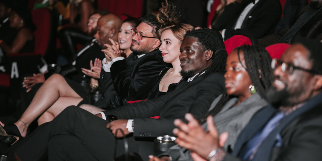 People sat in a cinema smiling
