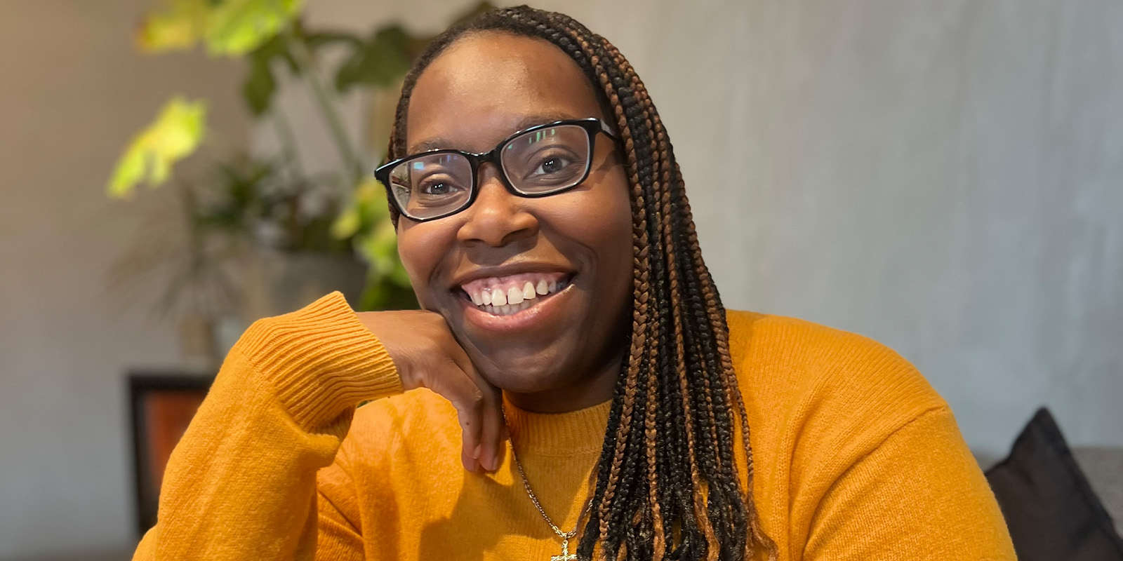 A woman in orange smiling into camera
