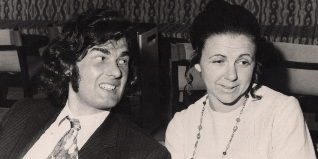 A man and woman smiling together