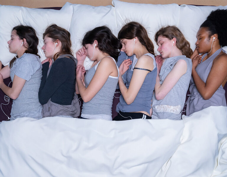 A group of women lying in bed