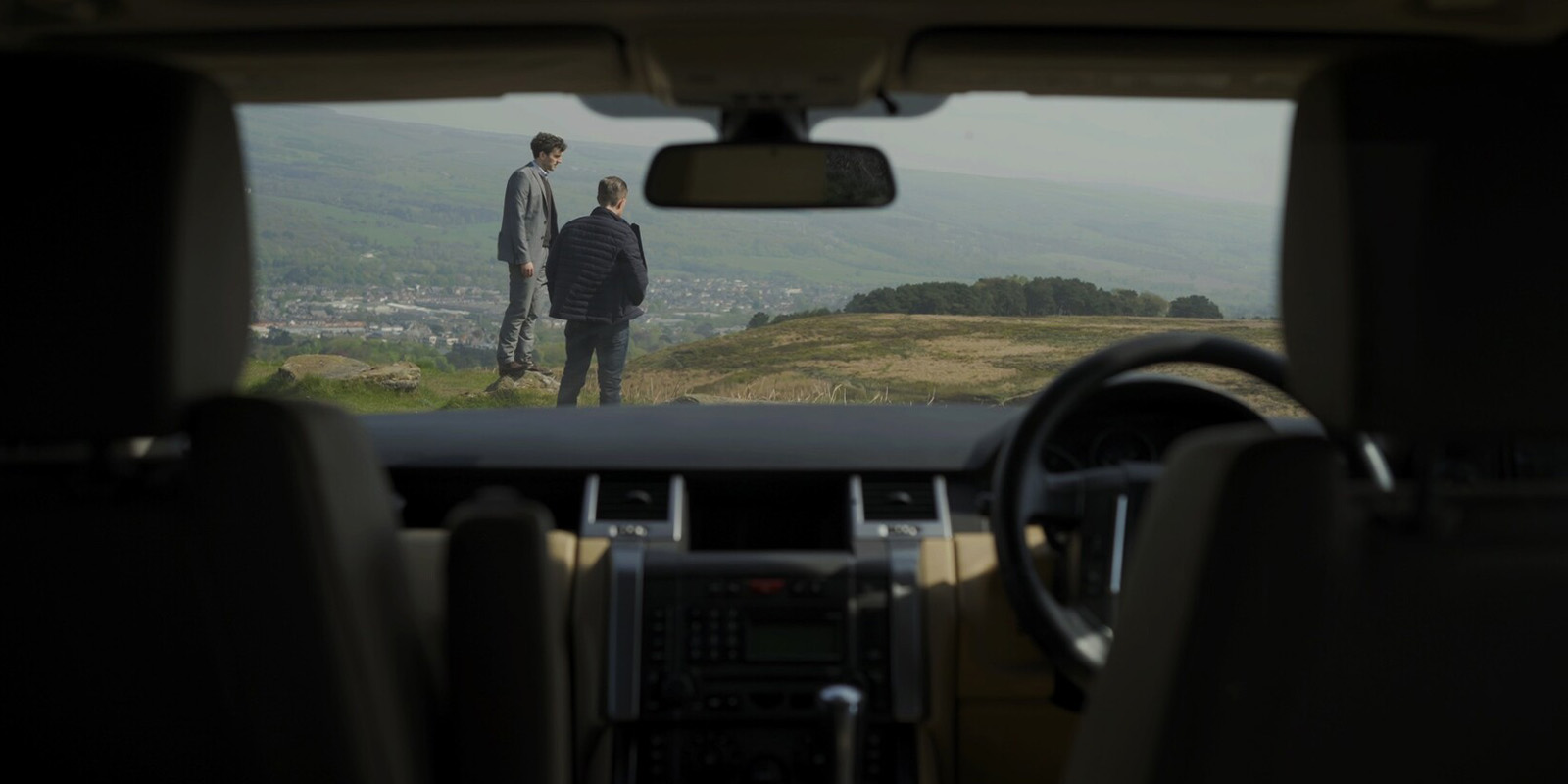 A view through a windshield looking at two men