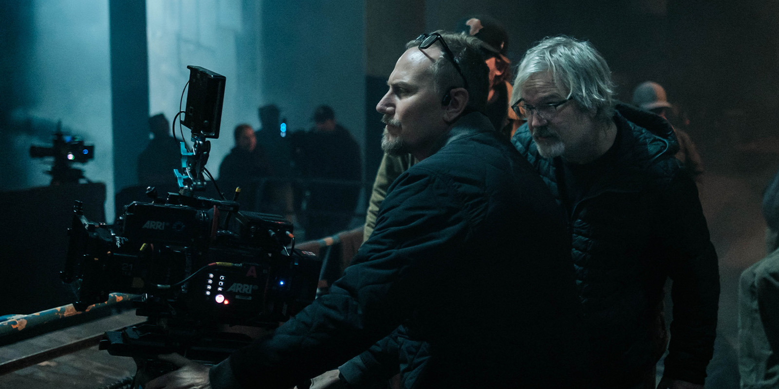 Film crew on set in a darkened room