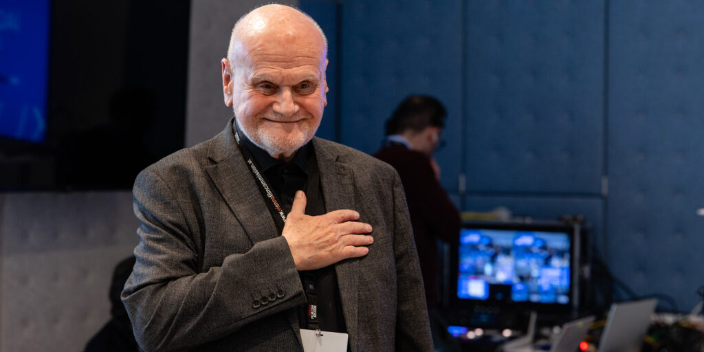 A man standing with his hand on his chest