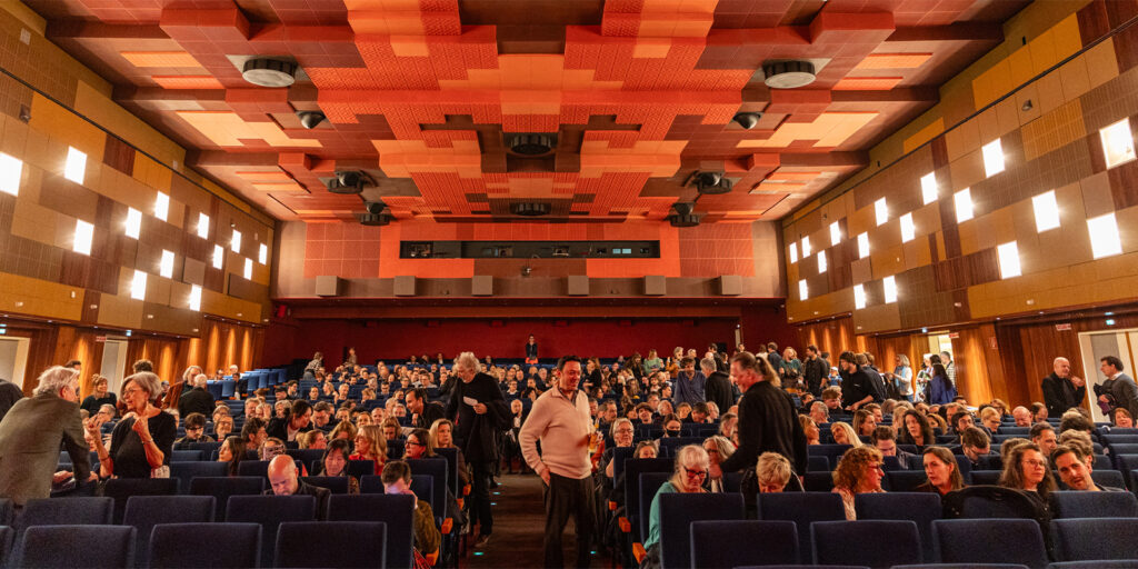 A large group of people gathered in an auditorium 