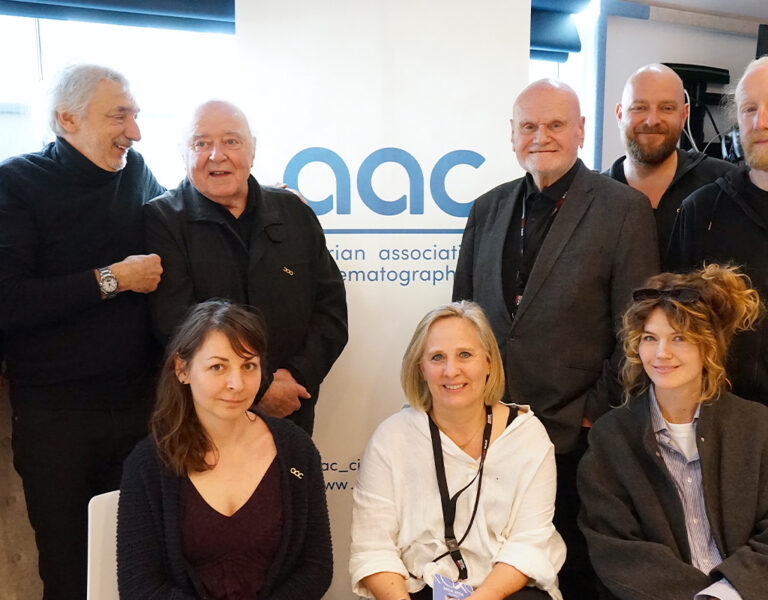 A group of people gathered by an AAC sign