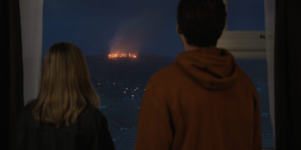 Two people overlooking a wildfire