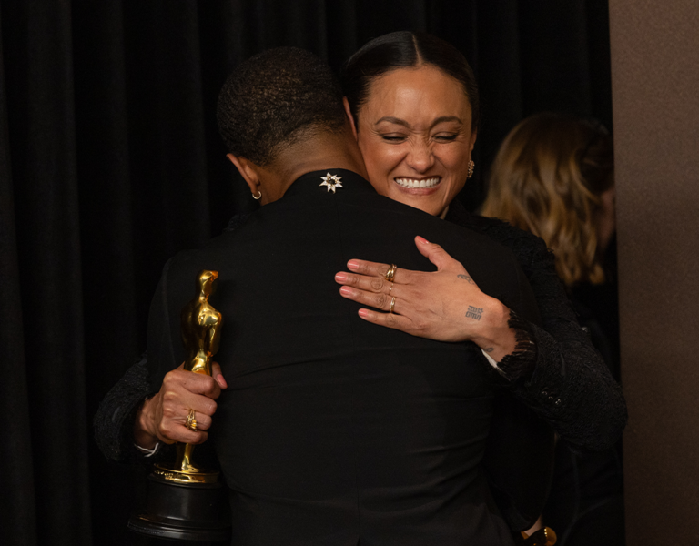 Autumn Durald Arkapaw ASC hugging a man while holding an Oscars trophy