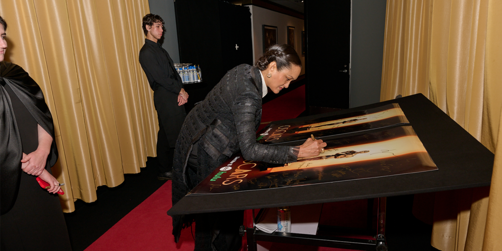 Autumn Durald Arkapaw backstage signing an Oscars poster