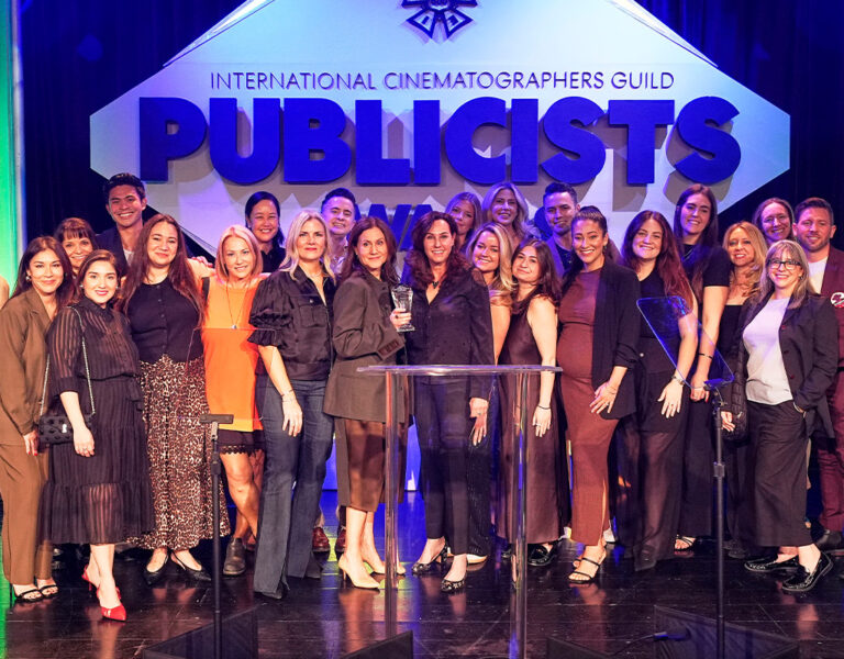 A group of people celebrating together on stage
