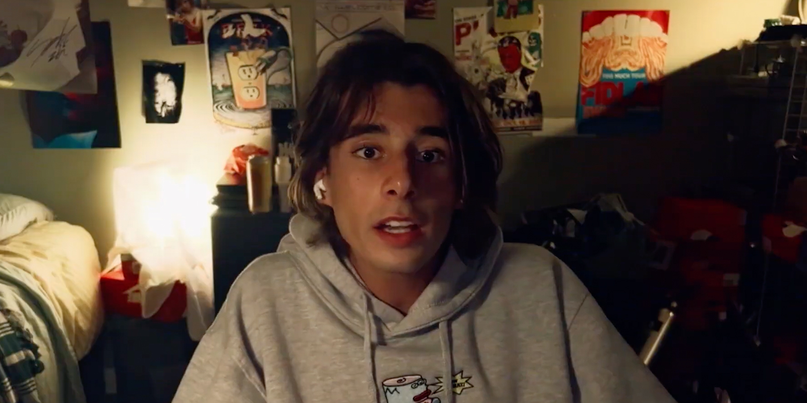A man sat in a grey hoodie