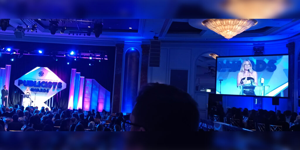 Kate Hudson on stage accepting an award