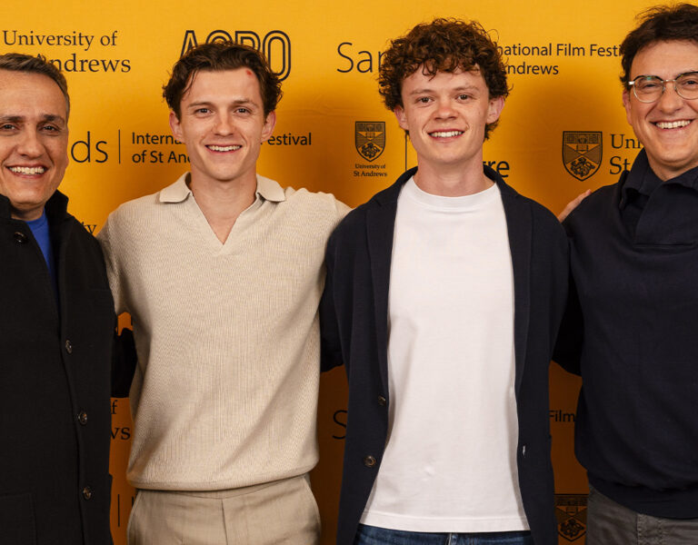 Four men stood together smiling