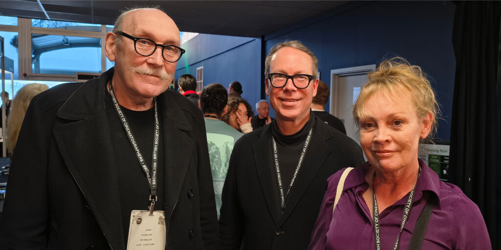 Three adults stand indoors at the BSC Expo 2026, wearing lanyards with badges. The man on the left has glasses and a moustache, the man in the centre has glasses, and the woman on the right has fair hair and wears a purple shirt.