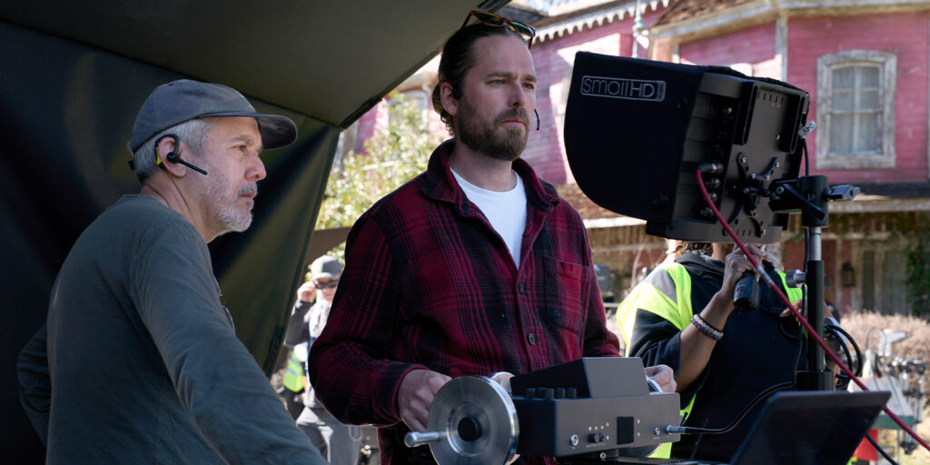 Two people stood behind a large camera