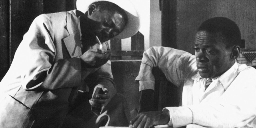 Two men sat together looking concerned