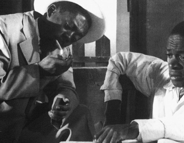 Two men sat together looking concerned