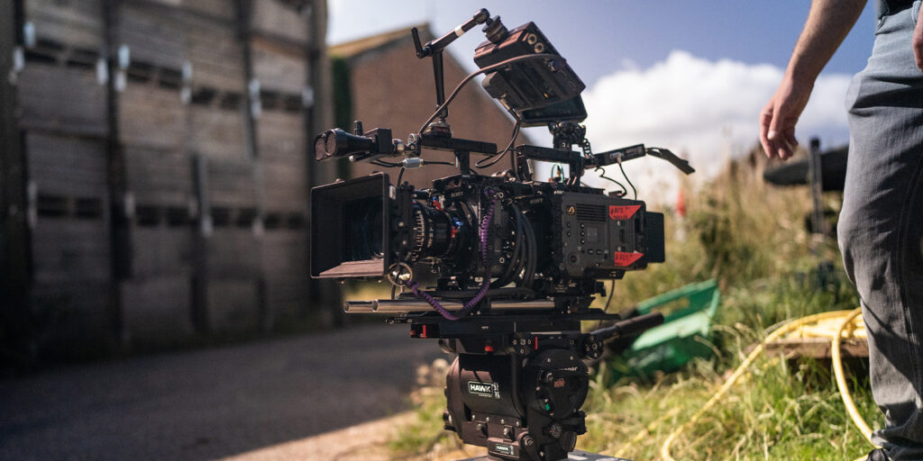 A large camera with a person stood next to it 