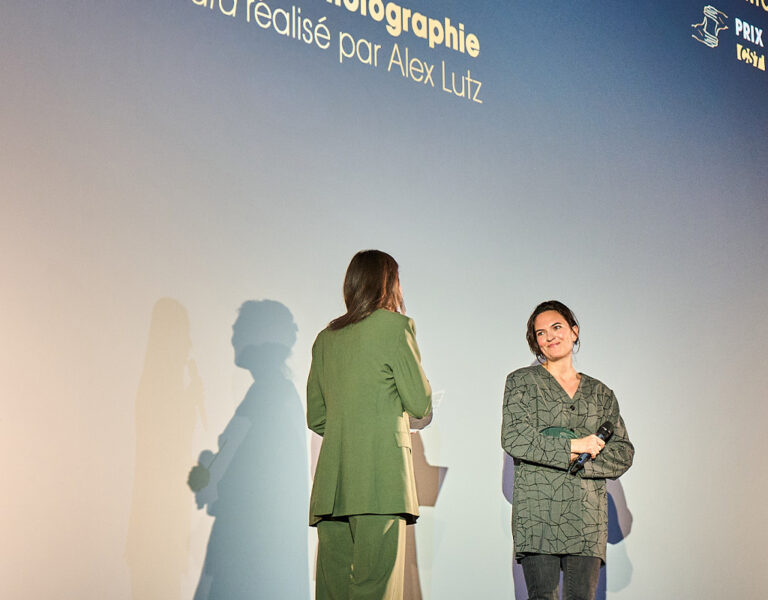 Two people on stage looking at each other
