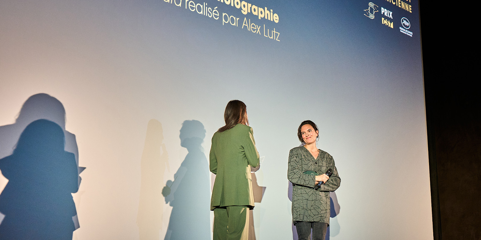 Two people on stage looking at each other