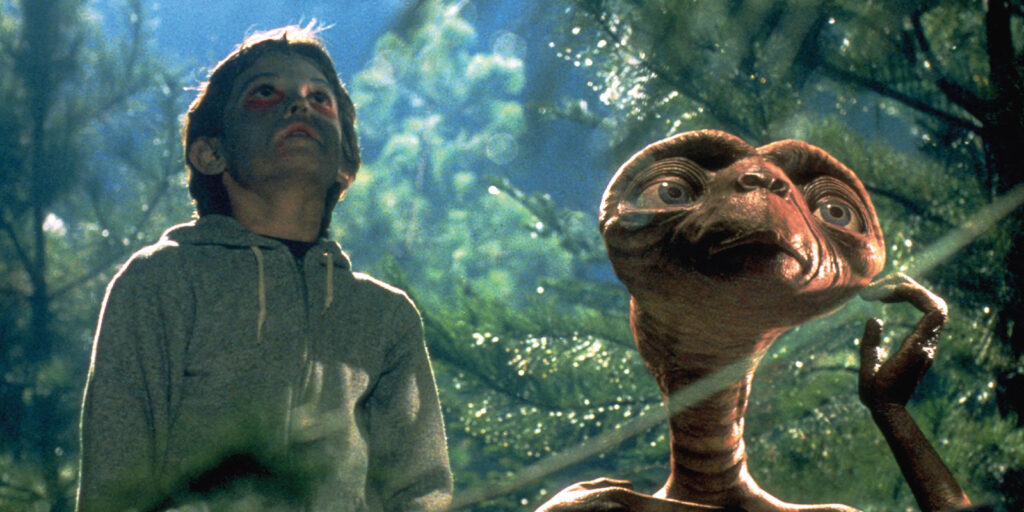 A boy and ET look skywards