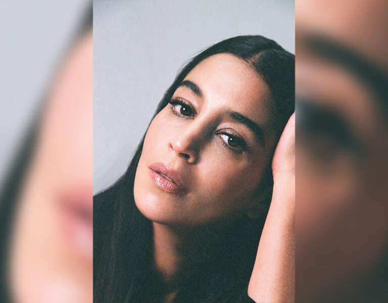 Leïla Bekhti resting her head on her hand