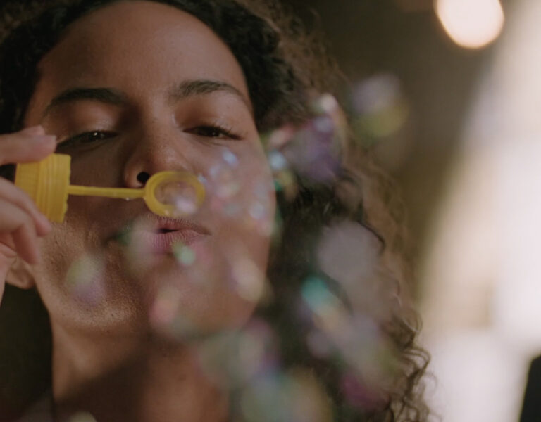 A woman blowing bubbles