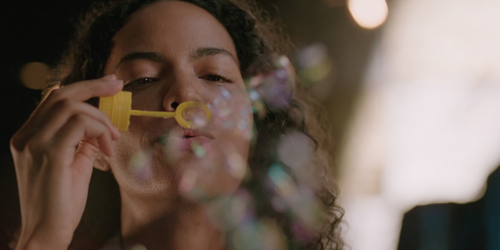 A woman blowing bubbles