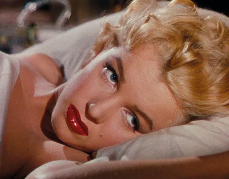 Marilyn Monroe lying in bed