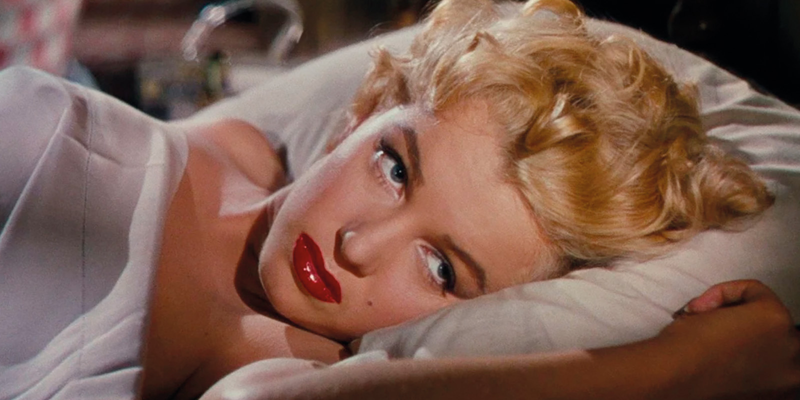 Marilyn Monroe lying in bed