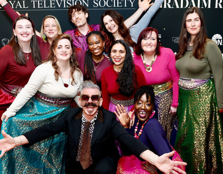 A group of people celebrating on the red carpet