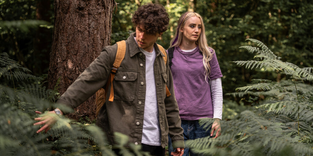 Two young people in the woods