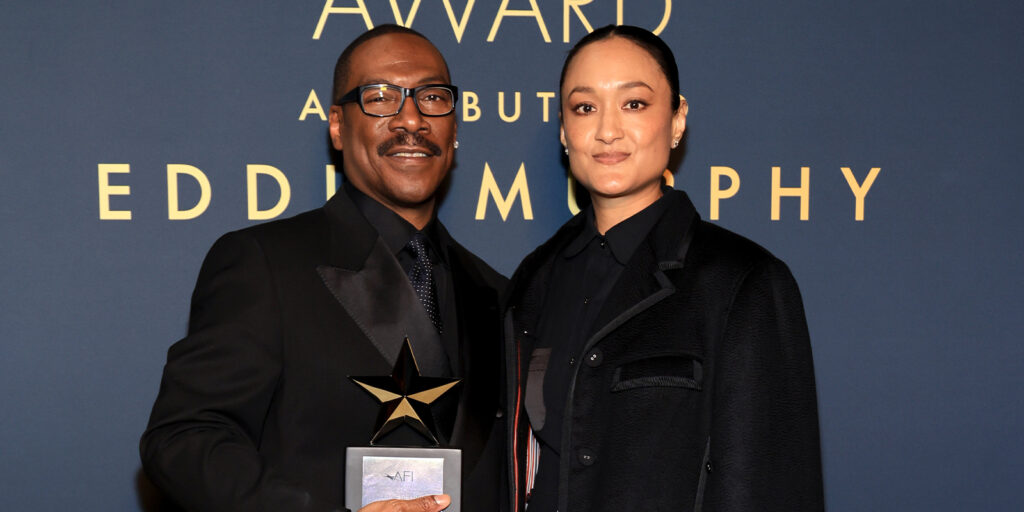 Eddie Murphy and Autumn Durald Arkapaw pose together on the red carpet