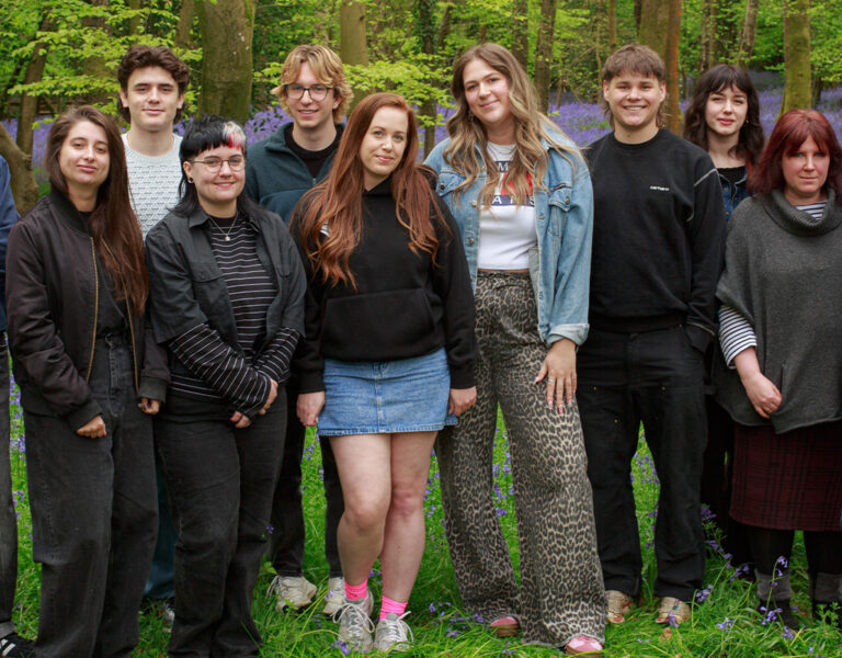 A group of people stood together smiling