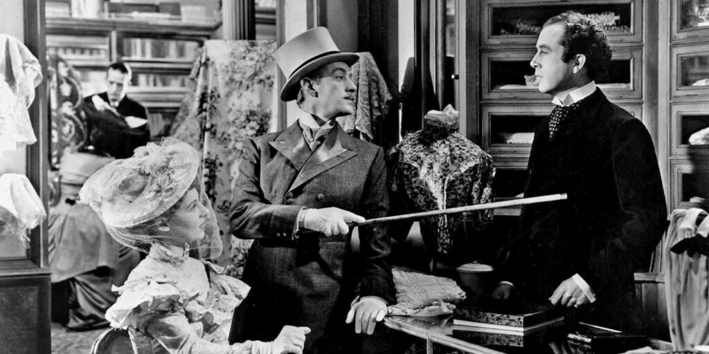 Three people in period attire in a store