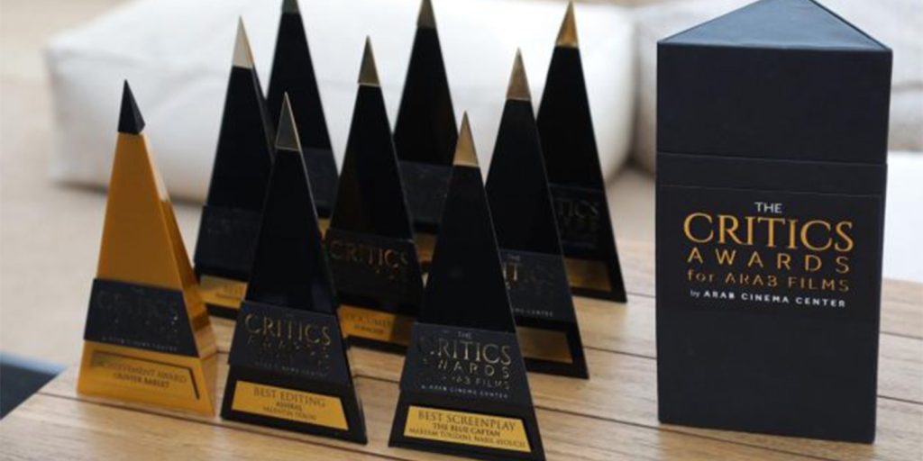 A collection of awards on a wooden table