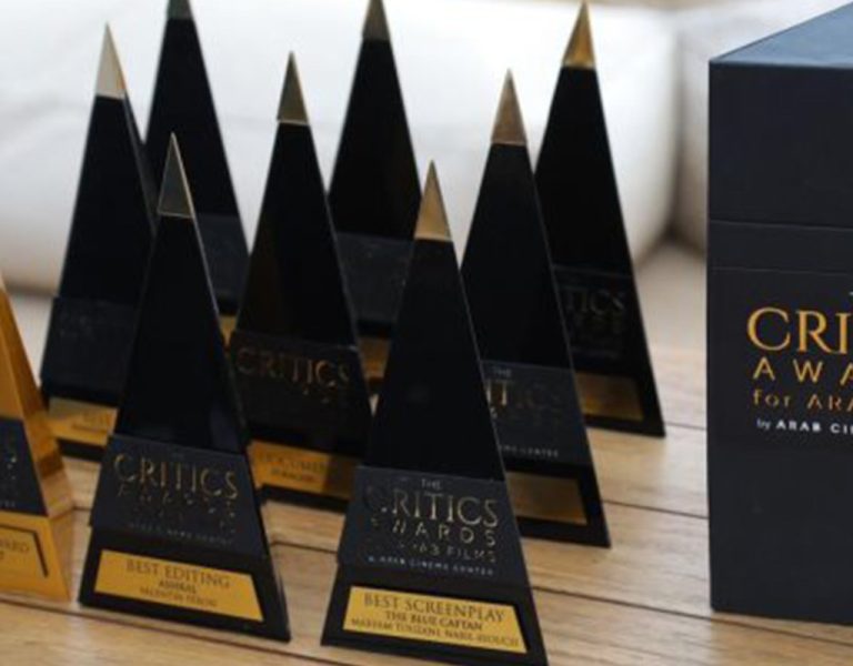 A collection of awards on a wooden table
