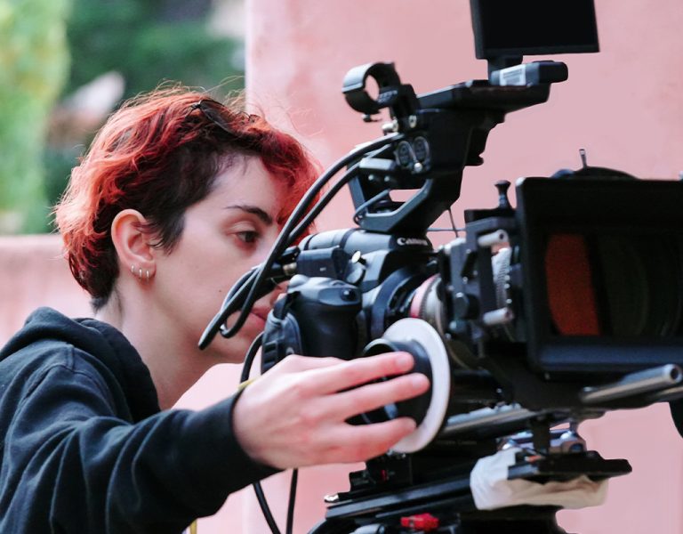 Ellie Michaelidis standing behind a camera