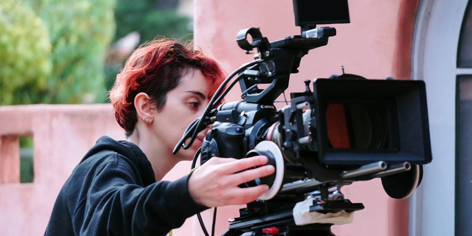 Ellie Michaelidis standing behind a camera