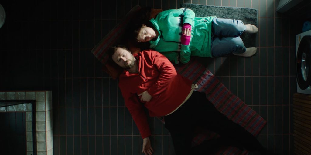 Two people lying on the ground together